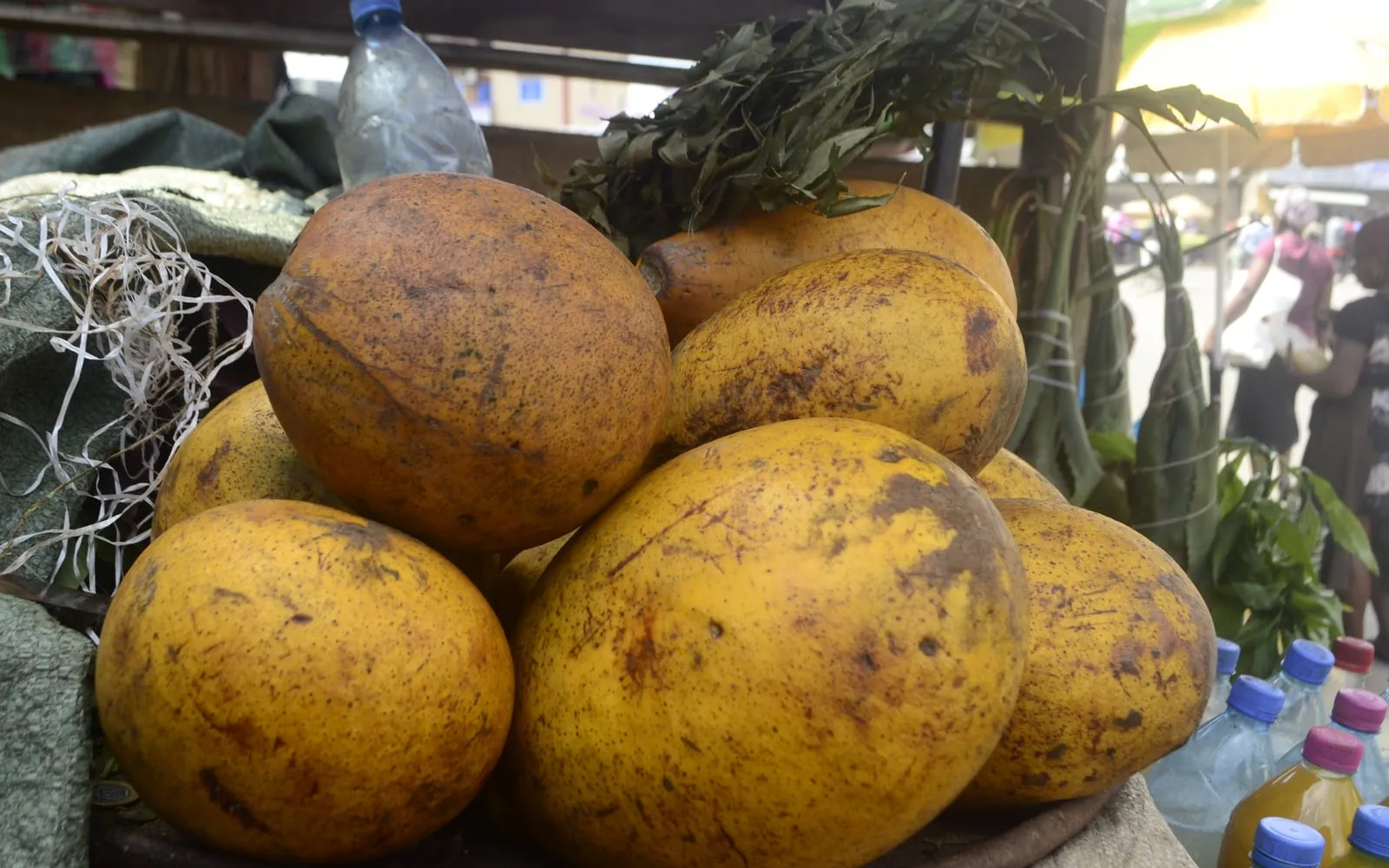 Ripe golden-yellow santol fruit piled at a market stall